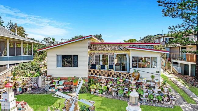 WINDMILL HOUSE: Generations of people of stopped to admire this house at 58 Shelley Beach Rd, Ballina which was decorated by former owner Peter Gutter with quirky tiled and decorated objects. Picture: Supplied