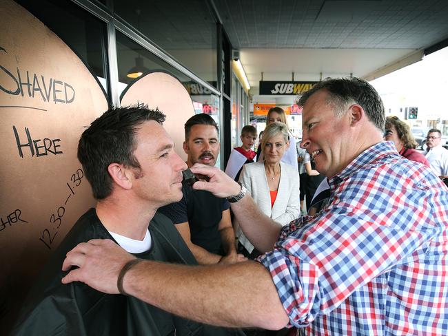 Tasmanian premier Will Hodgman shaves off Nick Corkhill's moustache to raise money for Movember. pic Sam Rosewarne