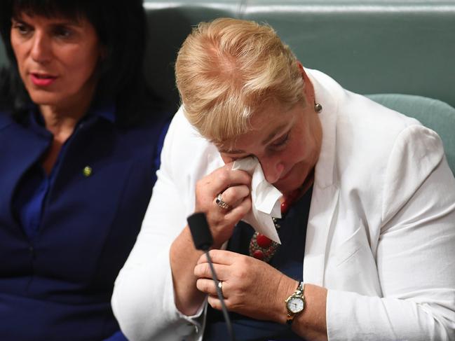 Liberal MP Ann Sudmalis wipes away tears during House of Representatives Question Time at Parliament House in Canberra, Wednesday, March 1, 2017. (AAP Image/Lukas Coch) NO ARCHIVING