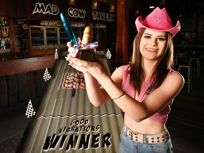 Mad Cow Tavern will be hosting its National Dildo Races tonight. Bartender Kristian Bowkett 21, with the winners trophy. Picture: Alix Sweeney