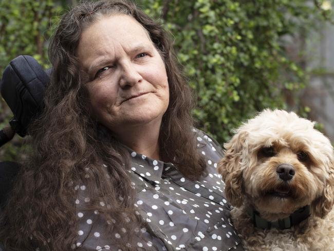 NWNAUSFEATURESBrenda Evans was a younger person with disability who spent time in a residential aged care facility, before coming out in 2016.She is telling her story of what it was like to be in aged care at 49.Brenda photographed at the Granny Flat she lives in at Nerang, Gold Coast, Qld. The dogs in pictures are Archie (Light colour) and Angus (dark)Removing young people with disabiity from aged care is one of the immediate priorities for government identified by the Royal Commission into aged care's interim report.Photography : Russell Shakespeare