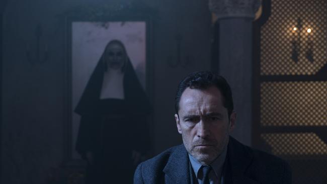 Bonnie Aarons as The Nun and Demian Bichir as Father Burke in a scene from  horror film "The Nun," a Warner Bros. Pictures release.