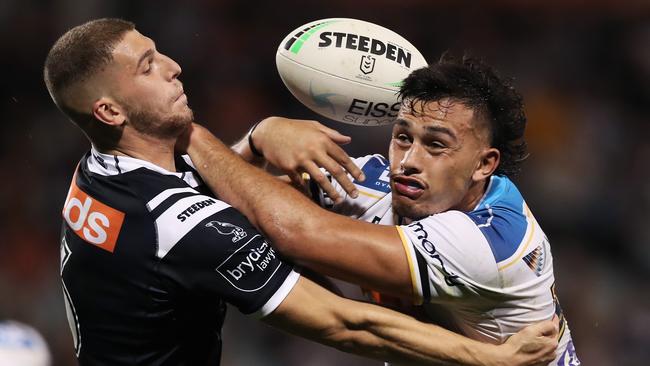 Adam Doueihi tackles Titans’ enforcer Tino Fa'asuamaleaui. Picture: Matt King/Getty Images