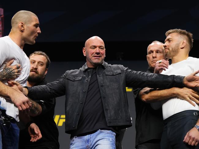 Strickland (L) and du Plessis (R) are separated by UFC president Dana White. Picture: Cooper Neill/Zuffa LLC via Getty Images