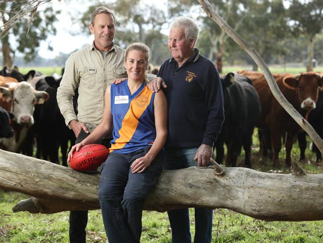 Does the punishment fit the crime? The SANFL has banned Casey McElroy, 27, for six games from playing with her women’s team because she played one game with a men’s reserves side. She’s pictured with her dad Bradley, 52, and grandfather Jeffrey, 81. Picture: TAIT SCHMAAL