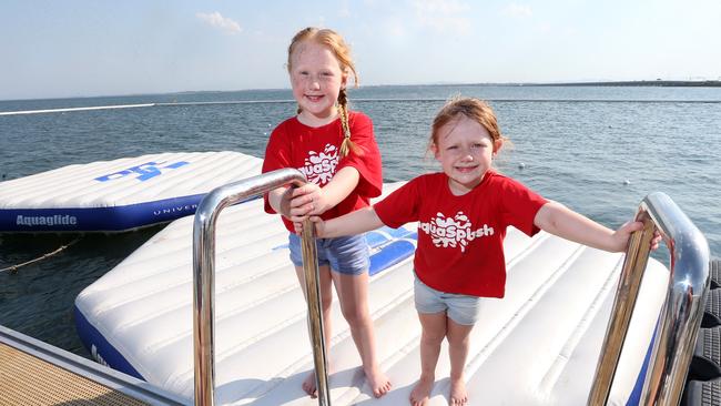 Sisters Lilly (7) and Charlotte (5) Wilson, ready for the inflatable water park to open. Picture: AAP/Jono Searle