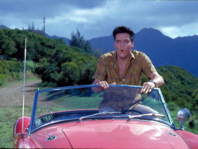Elvis and his red MG in a still from Blue Hawaii (1961). © EPE. Graceland and its marks are trademarks of EPE. All Rights Reserved. Elvis Presley™ © 2021 ABG EPE IP LLC.Elvis: Direct from Graceland brings some of the King of Rock 'n' Roll's most prized possessions from Graceland to the Bendigo Art Gallery. Picture - Supplied,  PLEASE NOTE WHEN PUBLISHING THIS IMAGE PLEASE INCLUDE IN THE CAPTION - , , © EPE. Graceland and its marks are trademarks of EPE. All Rights Reserved. Elvis Presley™ © 2021 ABG EPE IP LLC