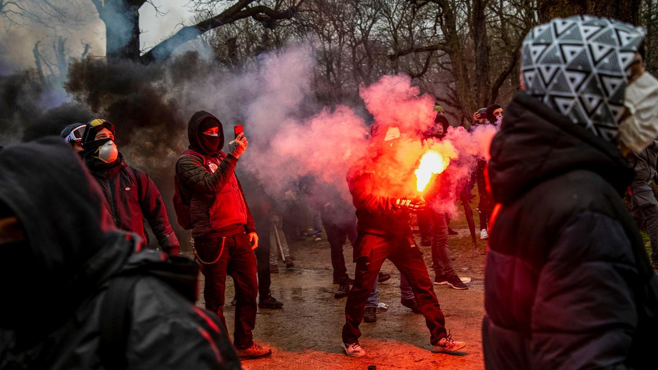 Protesters hold smoke bombs. Picture: Hatim Kaghat/Belga/AFP