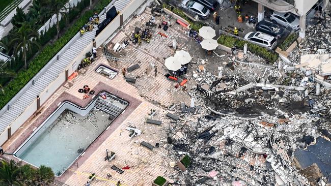 This aerial view, shows search and rescue personnel working on site after the partial collapse of the Champlain Towers South in Surfside, north of Miami Beach.