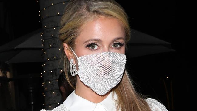 ONE TIME WEB USE ONLY - FEES APPLY FOR REUSE -  EXCLUSIVE: Paris Hilton stuns in a all white dress as she dines at Madeo restaurant with friends in Beverly Hills. Paris also protects herself with a shimmering face mask as she leaves Madeo restaurant in her older model grey Range Rover. 01 Jul 2020 Pictured: Paris Hilton. Photo credit: Photographer Group/MEGA TheMegaAgency.com +1 888 505 6342 (Mega Agency TagID: MEGA685626_001.jpg) [Photo via Mega Agency]