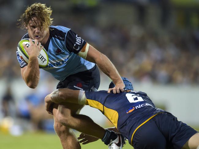 Michael Hooper of the Waratahs is tackled by David Horwitz of the Brumbies on Friday night.