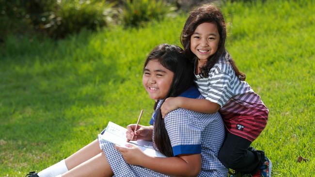 The mother of Siaila Vea, 7, and Soatame Vea, 4, makes them practice their handwriting regularly. Picture: Justin Lloyd