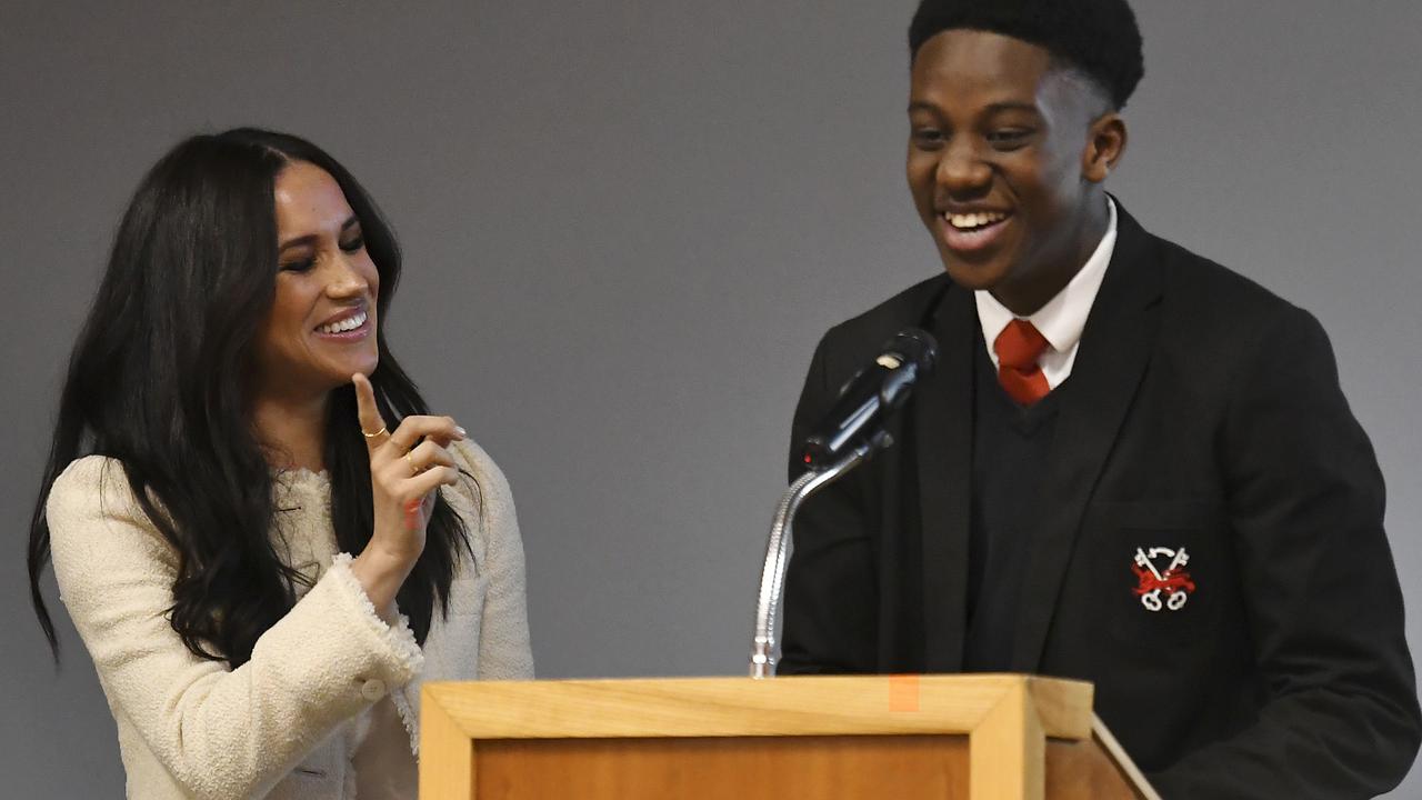 Meghan smiles as head boy Aker Okoye, speaks in a school assembly, during her surprise visit to the Robert Clack Upper School in Dagenham, Essex, in eastern London. Picture: Ben Stansall/Pool via AP