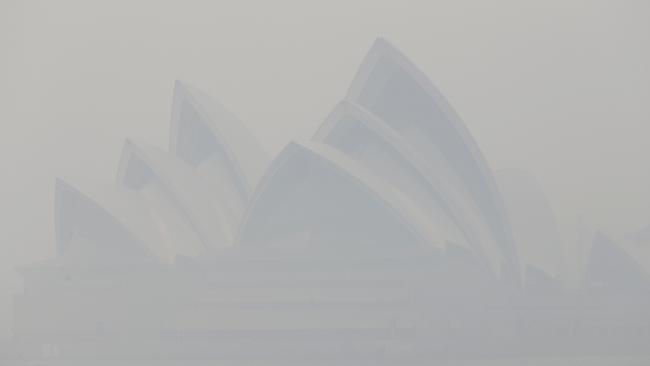 The Sydney Opera House is barely visible as the NSW environment department says visibility across the entire Sydney basin is at “hazardous” levels. Picture: Rick Rycroft. AAP