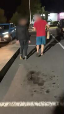 A group of children follow a delivery man to his car late at night