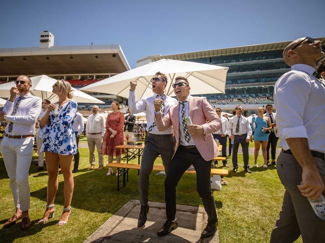 Incentivise fans Jimmy Condos and Rich Gioutsos cheer on their pick during a race. Picture: Jason Edwards