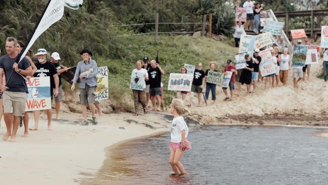 Residents and supporters gathered on the beach in 2021 to protest a proposed $900m development in Yaroomba.