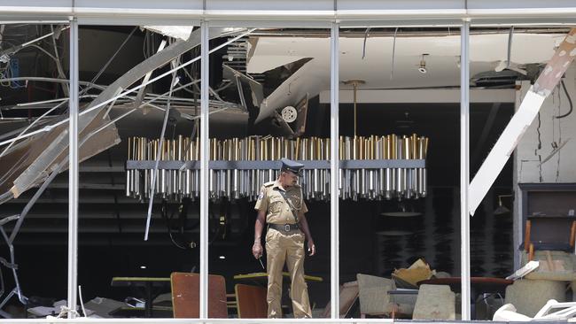 A policeman inspects the damage at the Shangri-la hotel in Colombo yesterday. Picture: AP