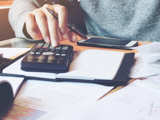 Man using calculator and calculate bills in home office.