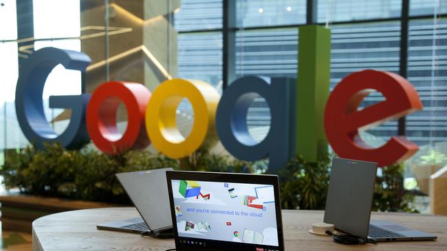 Google Inc. Chromebook laptop computers sit on display in front of a sign featuring the company's logo at the company's Asia-Pacific headquarters during its opening day in Singapore, on Thursday, Nov. 10, 2016. Google officially opened its new hub in Singapore today. Photographer: Ore Huiying/Bloomberg