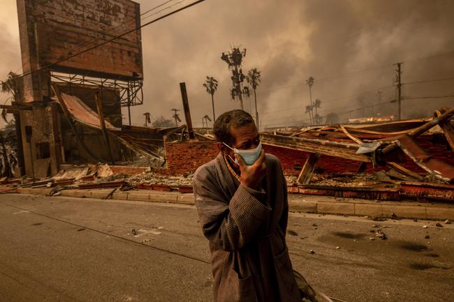 A man walks past a fire-ravaged business in Altadena. Picture: AP