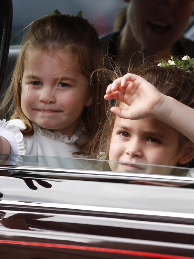 Flower Girls Princess Charlotte and Theodora Williams wave to the crowds following the wedding. Picture: AP