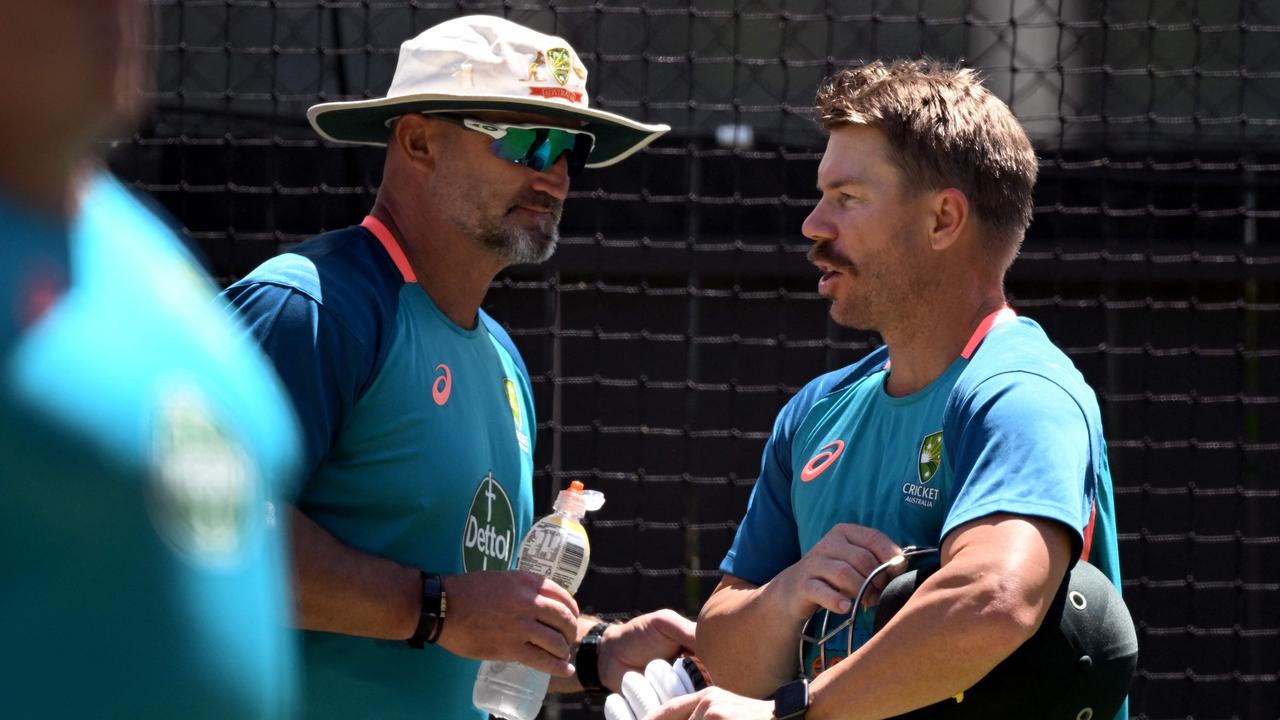 Australia's David Warner (R) speaks with assistant coach Michael Di Venuto (L) during a practice session at the Adelaide Oval ahead of the second cricket Test match against the West Indies in Adelaide on December 7, 2022. (Photo by William WEST / AFP)