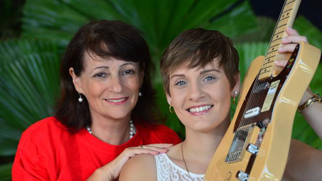 Former Mayor Jenny Hill with singer Michelle Plozza with the Fender guitar signed by Keith Urban which will be one of the auction items at the Mayor's Christmas Appeal charity auction luncheon. Picture: Evan Morgan