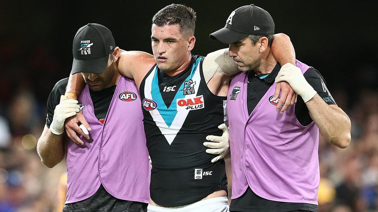 Port Adelaide’s Tom Rockliff was in a bad way after copping a knock against Brisbane.