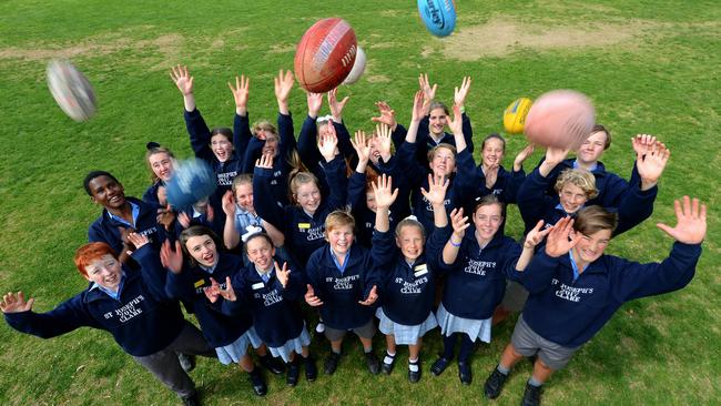 Year 7 students at Crows footballer Riley Knight's old school, St Joseph's School in Clare, ready to cheer him on in the AFL grand final. Picture: BERNARD HUMPHREYS