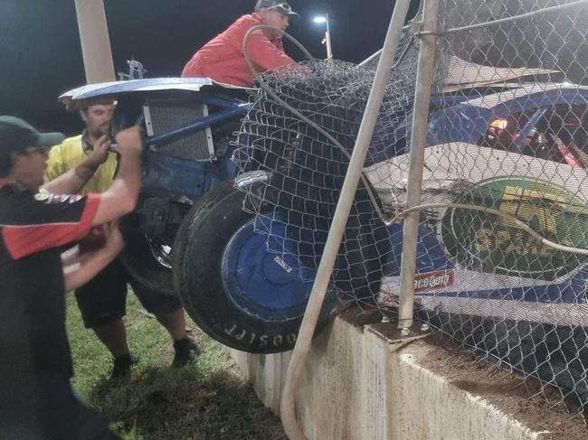 Volunteers work to remove the car and repair the fence. Photo: Kent Murray