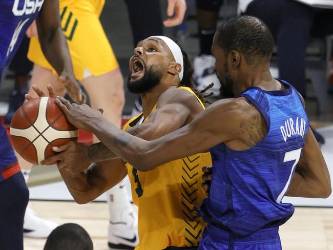LAS VEGAS, NEVADA - JULY 12:  Patty Mills #5 of the Australia Boomers is fouled by Kevin Durant #7 of the United States during an exhibition game at Michelob Ultra Arena ahead of the Tokyo Olympic Games on July 12, 2021 in Las Vegas, Nevada.  (Photo by Ethan Miller/Getty Images)