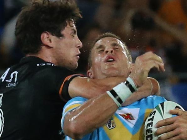 William Zillman (right) of Gold Coast Titans is tackled by Mitchell Moses of West Tigers during the 2015 NRL Season opener at the Cbus Super Stadium, Robina, Gold Coast.Picture: Regi Varghese