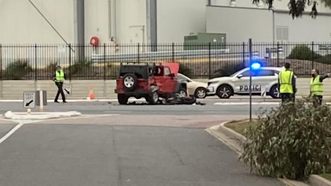 A red Jeep and a motorcycle have collided on Port Wakefield Rd at Gepps Cross.