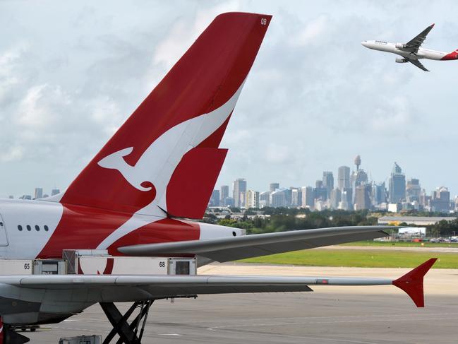 "Sydney, Australia - March, 14th 2012: Quantas aeroplanes and tail fin with the distant view of downtown Sydney - Sydney Airport". Picture: iStock