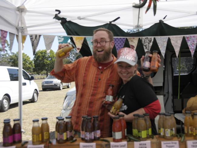 (From left) Chef Jasper Manfield and Malaika Gannon from Jasper In A Jar serving up some spicy sauces at Murphys Creek Chilli Carnival. Picture: Isabella Pesch