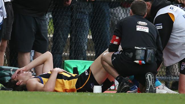 A devastated Max King gets his knee checked on the bench. Picture: Michael Klein