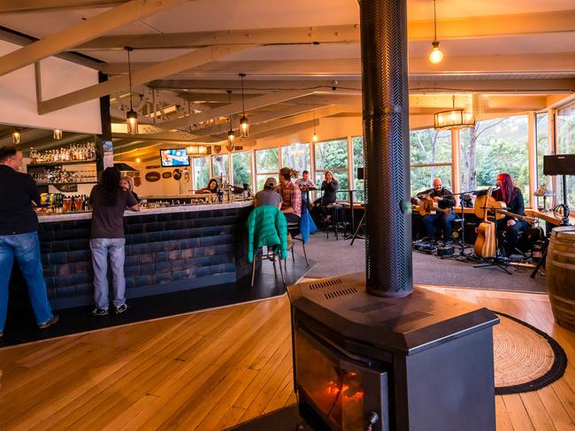 The cosy bar area at Pedder Wilderness Lodge, which clad in King Billy pine shingles from the Lake Margaret pipeline. Picture: Supplied by Pedder Wilderness Lodge.