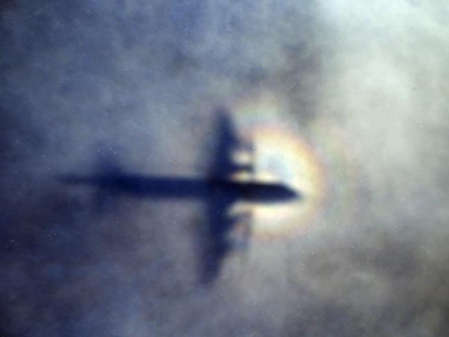 FILE - In this March 31, 2014, photo, the shadow of a Royal New Zealand Air Force P3 Orion is seen on low level cloud while the aircraft searches for missing Malaysia Airlines Flight MH370 in the southern Indian Ocean, near the coast of Western Australia. Part of the mystery of what happened to a Malaysia Airlines plane that vanished last year may be solved with air safety investigators confident that debris found in the Indian Ocean is a wing part unique to the Boeing 777, the same model as the missing jet, a U.S. official said Wednesday, July 29, 2015. Air safety investigators — one of them a Boeing investigator —have identified the component that was found on the French island of Reunion in the western Indian Ocean as a "flaperon" from the trailing edge of a 777 wing, the U.S. official said. (AP Photo/Rob Griffith, File)