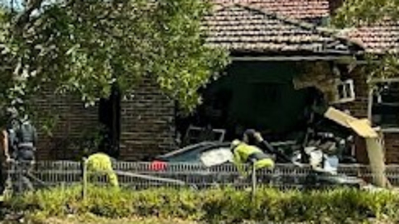 Woman dead after car ploughs into home