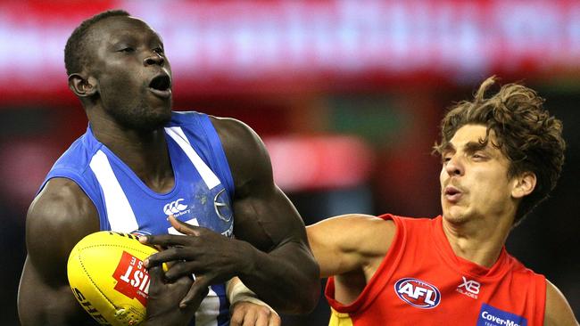 Majak Daw of the Kangaroos marks under pressure from Sean Lemmens of the Suns. Picture: AAP Image/Hamish Blair