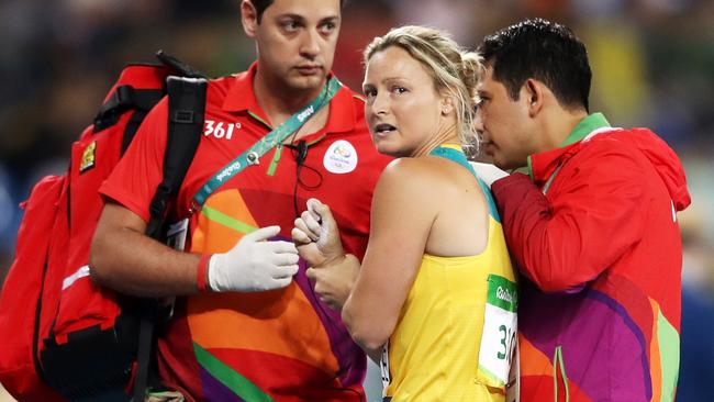 Kim Mickle was assisted by medical staff after being injured during the women's javelin throw