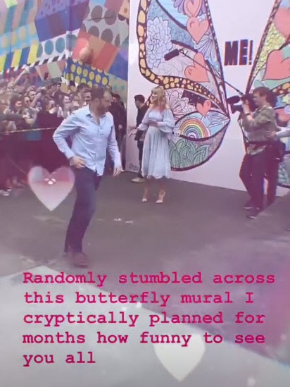 Taylor Swift drops by her mural.