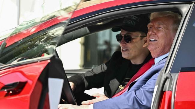 Donald Trump and Tesla CEO Elon Musk speak to the press as they sit in a Tesla vehicle on the South Portico of the White House. Picture; AFP.