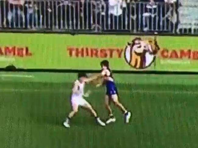 Andrew Gaff throws a punch at Andrew Brayshaw.