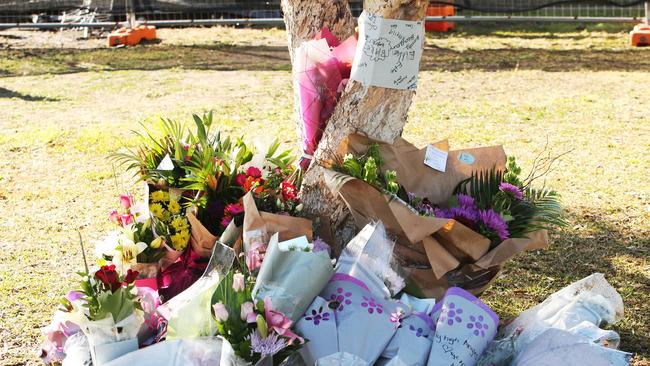 Tributes are flowing in front of the burnt out house. Picture: Peter Lorimer.