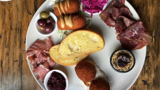 The tasting platter featuring housemade charcuterie, croquettes and black garlic butter that’s “the stuff of dreams”. <br/>