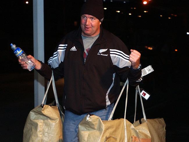 All Blacks manager Tony Thorpe helps with the bags as the team arrives at Carisbrook.