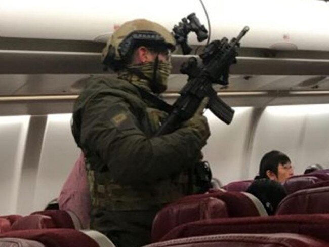 Heavily-armed police board Malaysia Airlines flight MH128 at Melbourne Airport after a man claimed to have a bomb and tried to get into the cockpit. Picture: Andrew Leoncelli