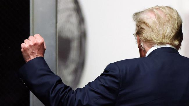 Donald Trump holds up a fist as he walks to the courtroom after the start of deliberations in his criminal trial at Manhattan Criminal Court. Picture: AFP.